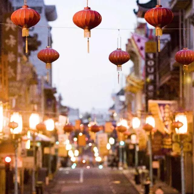 Close-up view of a string of red lanterns hanging above a street in Chinatown. San Francisco, California.